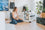 girl in her modern home, looking at her dog inside of a white collapsible dog crate