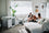 a family sitting in their modern living room with their two dogs and two Impact dog crates