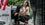 bernese mountain dog being pet by her mom with the corner of the American flag draping down on the white collapsible dog crate