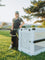 Brittany Straw standing with her dog in front of a white collapsible dog crate