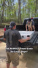 2 people loading a large white 54 inch collapsible crate into the back of a truck