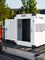 a white stationary dog crate with a puppy divider installed sitting in the back of a truck